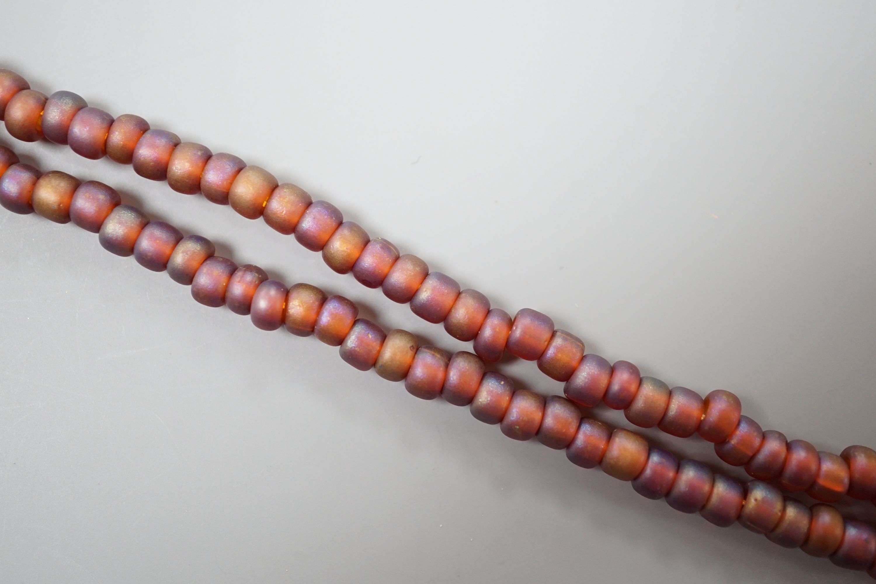 A single strand iridescent art glass bead necklace, with yellow metal clasp, 56cm.